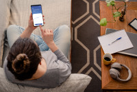 Overhead view of a person sitting cross legged holding a phone