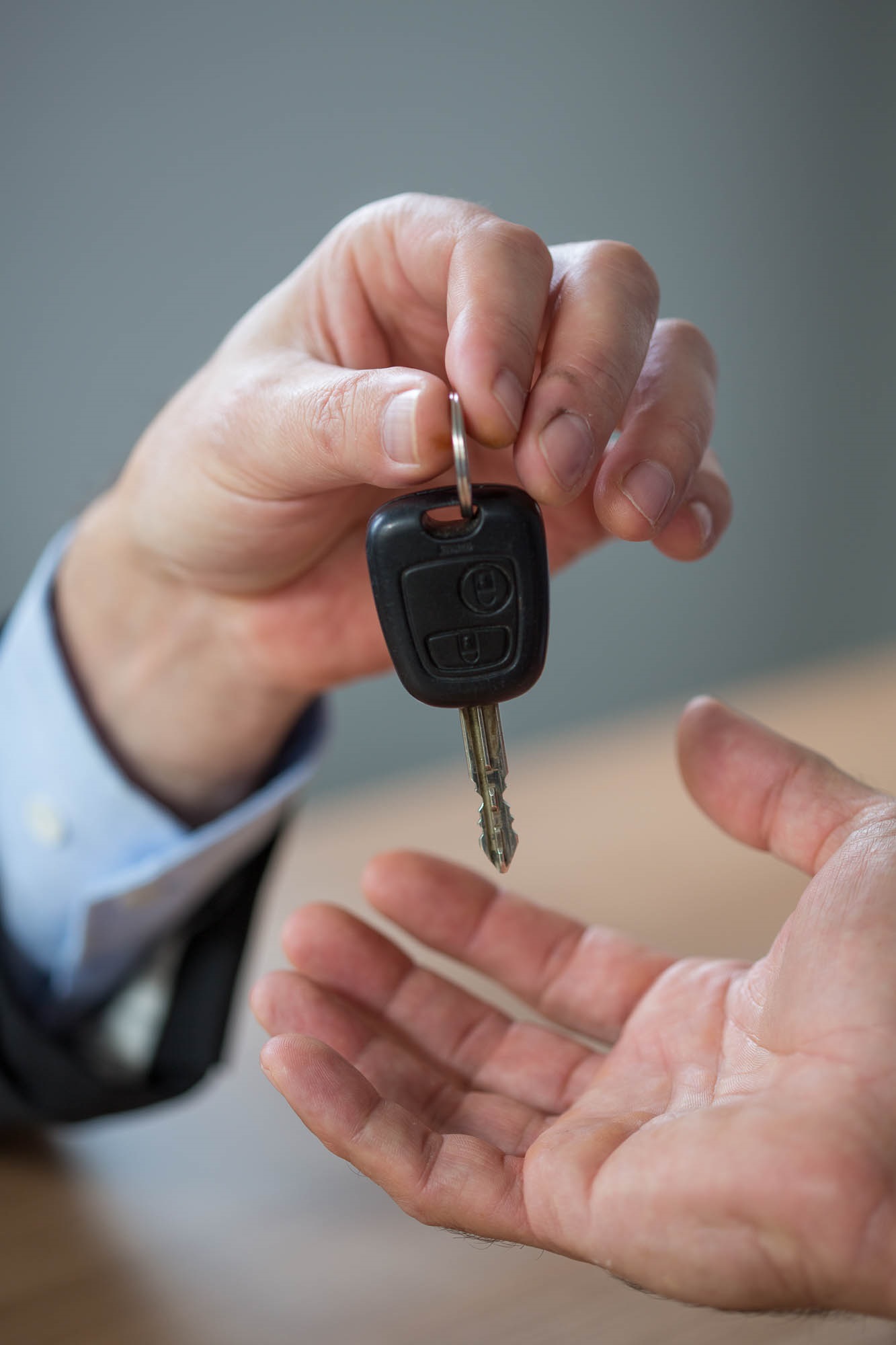 Person handing car keys to another
