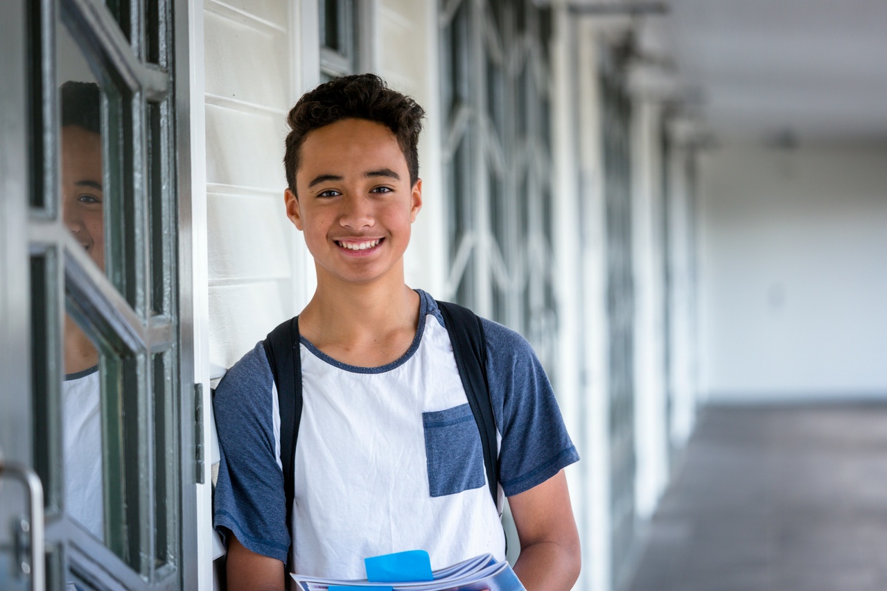 Young teenager wearing school bag
