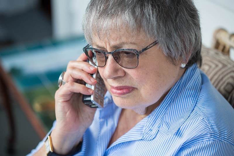 Women using phone while sitting in chair