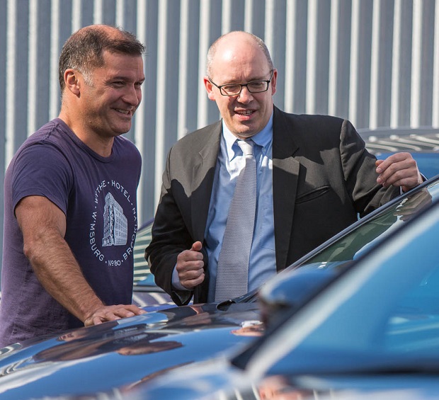 Two men looking at car