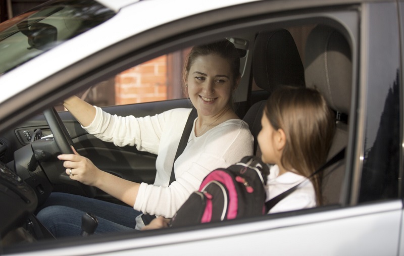 Mother and daughter talking in car