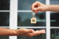 House keys being handed from one hand to another