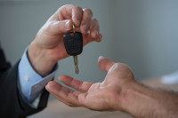 Man handing over a car key