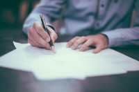 Photo of hands writing on paper